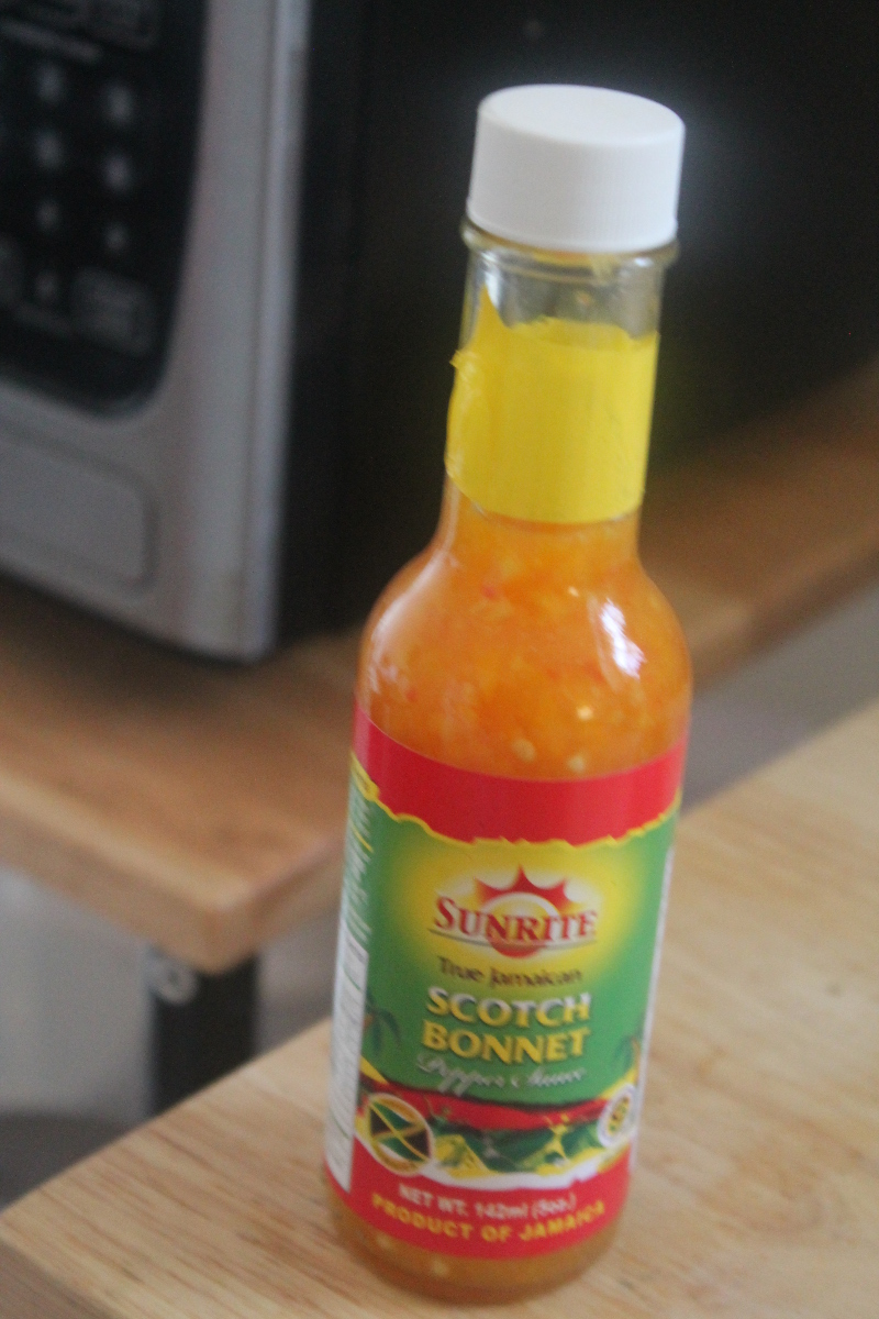 bottle of scotch bonnet pepper in front of microwave